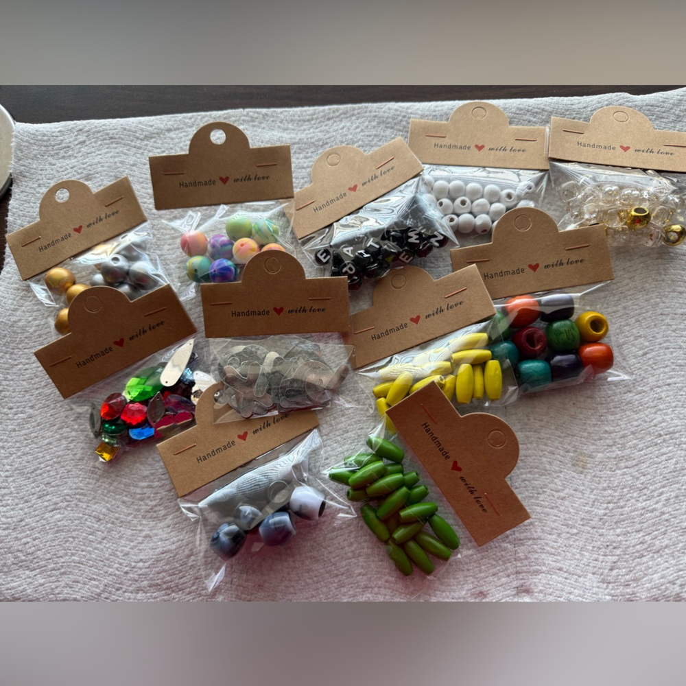 Bundle of 11 packs of beads. Various types